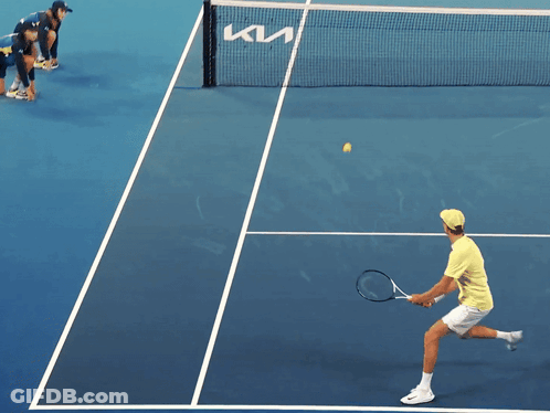 Tennis Player Serving On Blue Court GIF