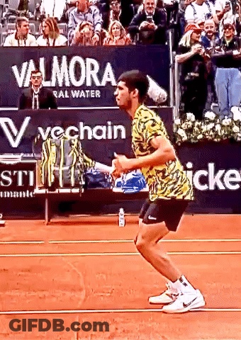 Tennis Player Squatting In Front Of Valmora Sign GIF