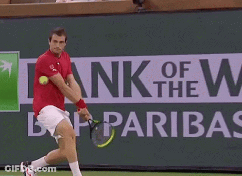 Tennis Player Swinging Racket In Front Of BNP Paribas Sign GIF
