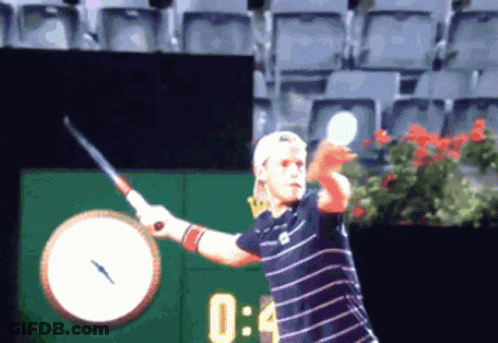 Tennis Player Swinging Racket In Front Of Clock Saying 0:04 GIF