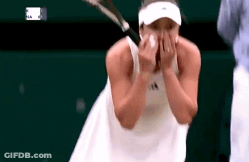Tennis Player Wiping Face While Holding Racquet GIF