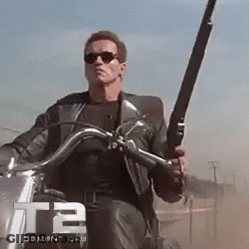 Terminator Arnold Schwarzenegger Shooting While Riding A Motor Bike GIF