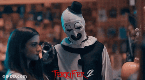 Terrifier 2 Poster Clown Standing Next To Girl GIF