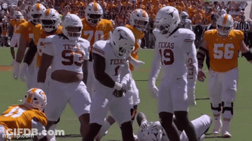 Texas Football Players Standing On Field GIF