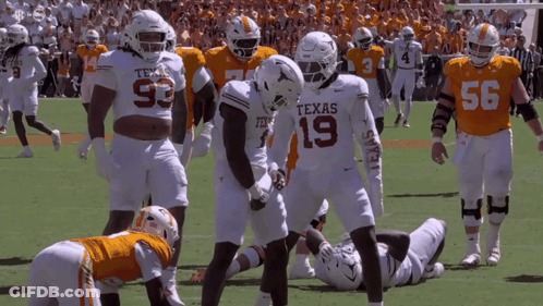 Texas Football Players Standing On Field GIF