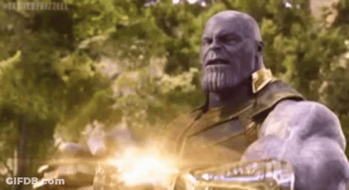 Thanos From Avengers : Infinity War Is Holding A Glowing Glove In His Hand . GIF