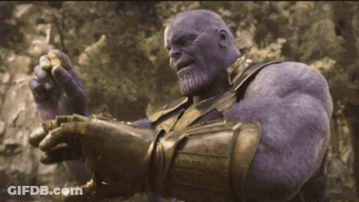 Thanos From Avengers Infinity War Is Holding A Gold Ring In His Hand . GIF