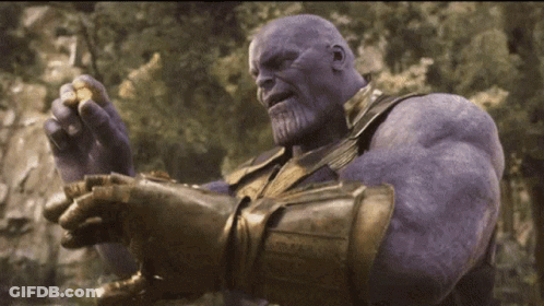 Thanos From Avengers Infinity War Is Holding A Piece Of Gold In His Hand . GIF