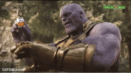 Thanos Holding Lighter In Front Of Wall Street Bulls Sign GIF
