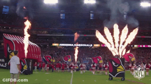 The Arizona Cardinals Cheerleaders Are On The Field With Fireworks GIF