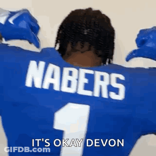 The Back Of A Football Player Wearing A Blue Jersey With The Name Nabers On The Back . GIF