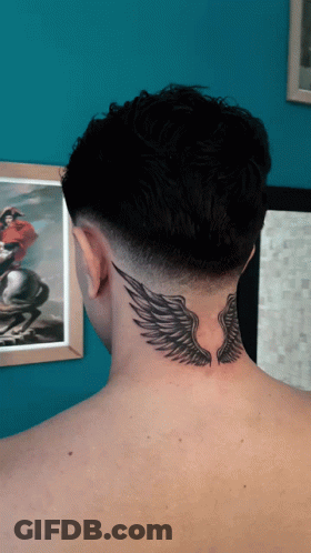 The Back Of A Man 'S Neck Has A Tattoo Of Wings On It GIF