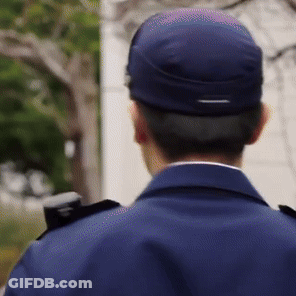 The Back Of A Man Wearing A Blue Uniform And A Blue Hat GIF