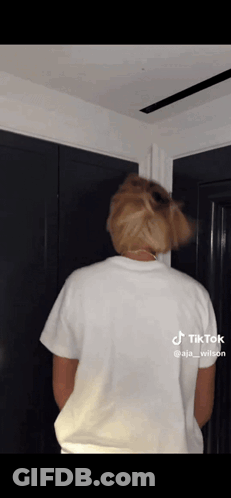 The Back Of A Person Wearing A White T-Shirt Is Shown GIF