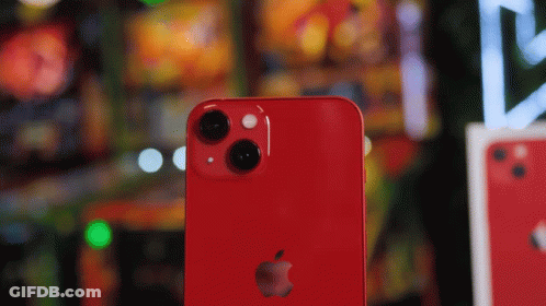The Back Of A Red Apple Iphone With A Blurred Background GIF