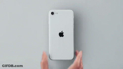 The Back Of A White Apple Iphone Se Is Shown On A Gray Surface . GIF