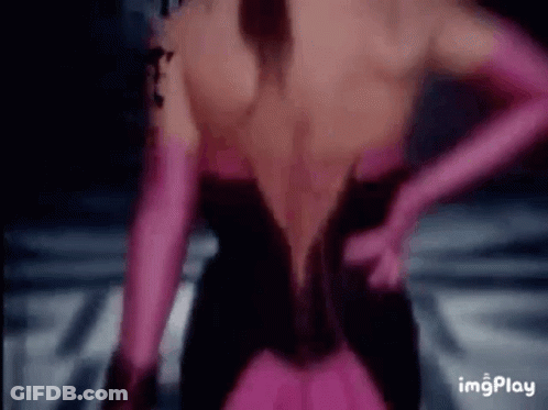 The Back Of A Woman Wearing A Black Dress And Pink Gloves . GIF