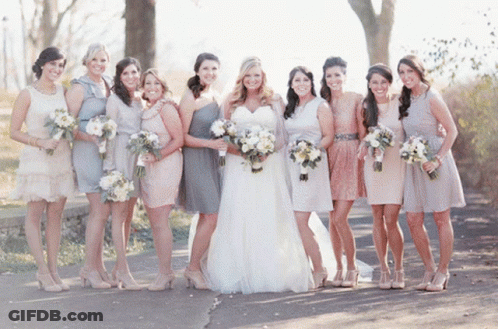 The Bride And Her Bridesmaids Pose For A Photo GIF