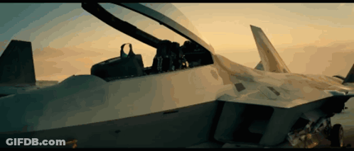 The Cockpit Of A Fighter Jet With The Canopy Open And A Sunset In The Background GIF