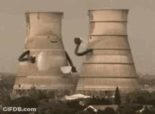 The Cooling Towers Of A Power Plant Are Being Demolished . GIF