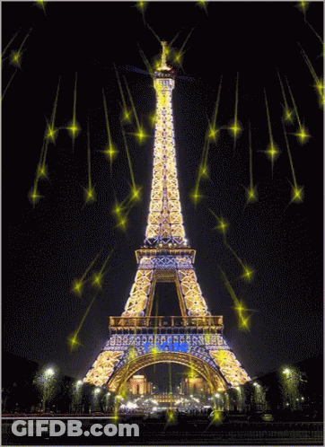 The Eiffel Tower Is Lit Up At Night And Surrounded By Sparkling Stars GIF