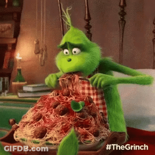 The Grinch From The Movie The Grinch Is Eating Spaghetti And Meatballs With A Fork . GIF