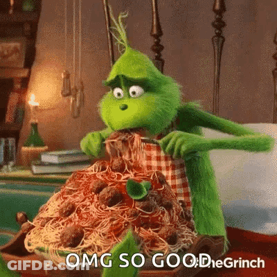 The Grinch From The Movie The Grinch Is Eating Spaghetti And Meatballs With A Fork And Knife . GIF