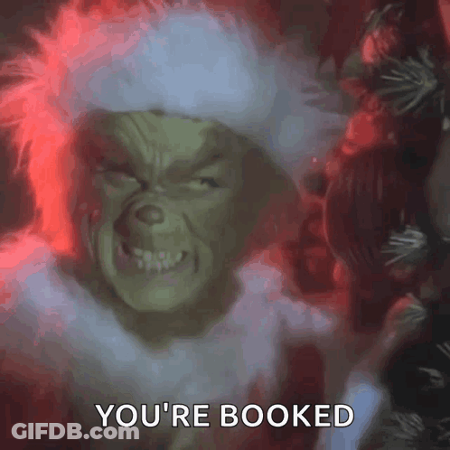 The Grinch From The Movie The Grinch Is Looking At The Camera And Saying `` You 'Re Booked '' . GIF