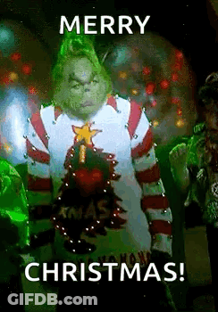 The Grinch From The Movie The Grinch Is Wearing A Christmas Sweater And Holding A Christmas Tree . GIF