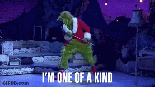 The Grinch Is Wearing A Santa Suit And Holding A Stick While Dancing On A Stage . GIF