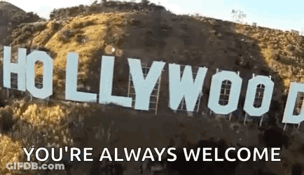 The Hollywood Sign Is Sitting On Top Of A Hill With The Words `` You 'Re Always Welcome '' Written Below It . GIF