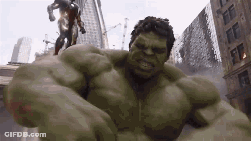 The Hulk Is Fighting Iron Man In A City In A Superhero Movie . GIF