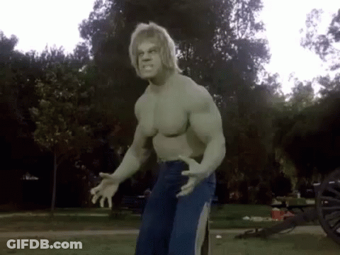 The Hulk Is Standing In A Park With His Arms Outstretched . GIF