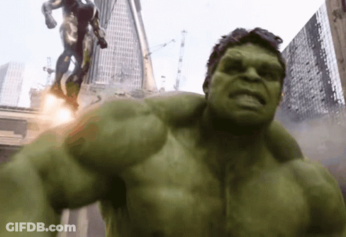 The Hulk Is Standing In Front Of A Statue Of A Man GIF