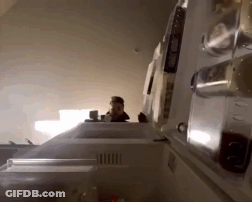 The Inside Of A Refrigerator With The Door Open And A Person Standing Behind It GIF