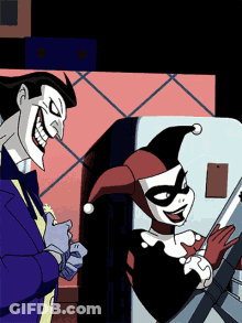 The Joker And Harley Quinn Are Standing Next To Each Other And Smiling GIF