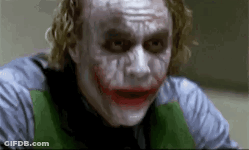 The Joker From The Movie The Dark Knight Is Making A Funny Face While Looking At The Camera . GIF