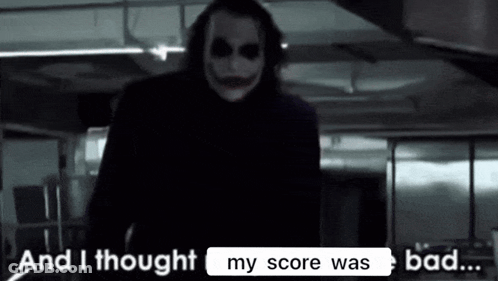 The Joker From The Movie The Dark Knight Rises Is Standing In A Dark Room . GIF