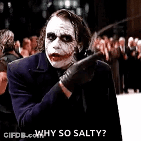 The Joker Is Holding A Knife In His Hand And Pointing At Someone . GIF