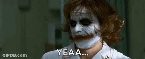 The Joker Is Wearing A Nurse 'S Uniform And A White Mask On His Face . GIF