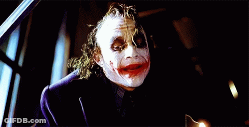 The Joker Is Wearing A Purple Jacket And A Black Shirt GIF