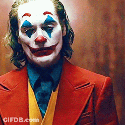 Joker In Red Suit And Blue Tie GIF