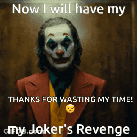 The Joker Is Wearing A Suit And Tie And Has A Sad Face On His Face . GIF
