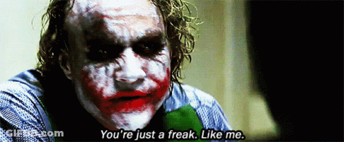 The Joker Says " You 'Re Just A Freak Like Me " In A Dark Room GIF