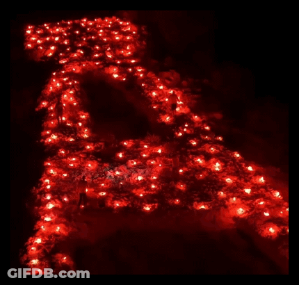 The Letter A Is Lit Up In Red Candles GIF