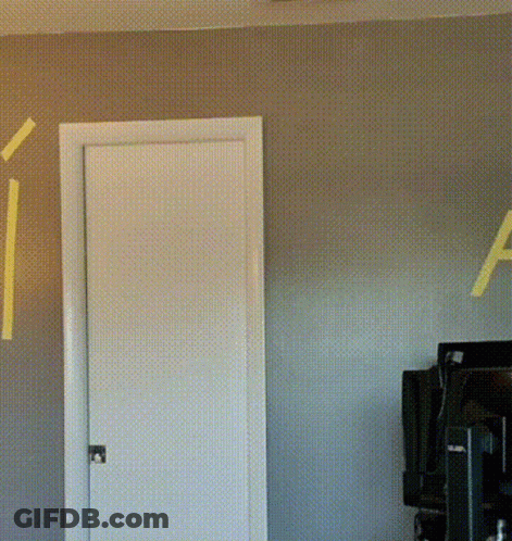 The Letter A Is Painted On The Wall Behind A Door GIF