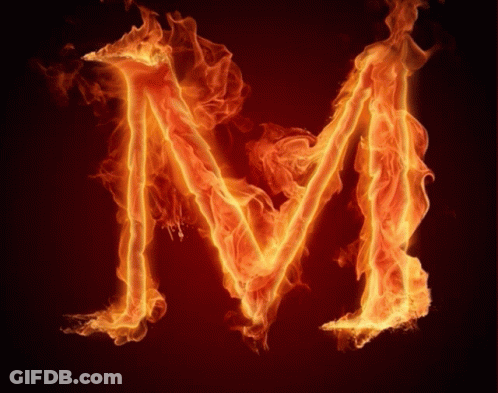 The Letter M Is Made Of Flames On A Dark Background GIF