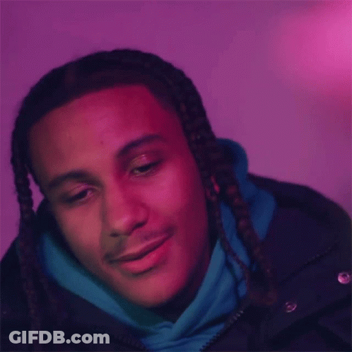 The Man Is Wearing A Blue Hoodie And A Black Jacket And Is Smiling . GIF