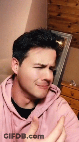 The Man Is Wearing A Pink Hoodie And Making A Funny Face GIF