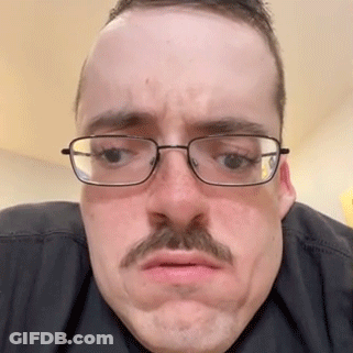 The Man Is Wearing Glasses And A Mustache And Making A Funny Face . GIF